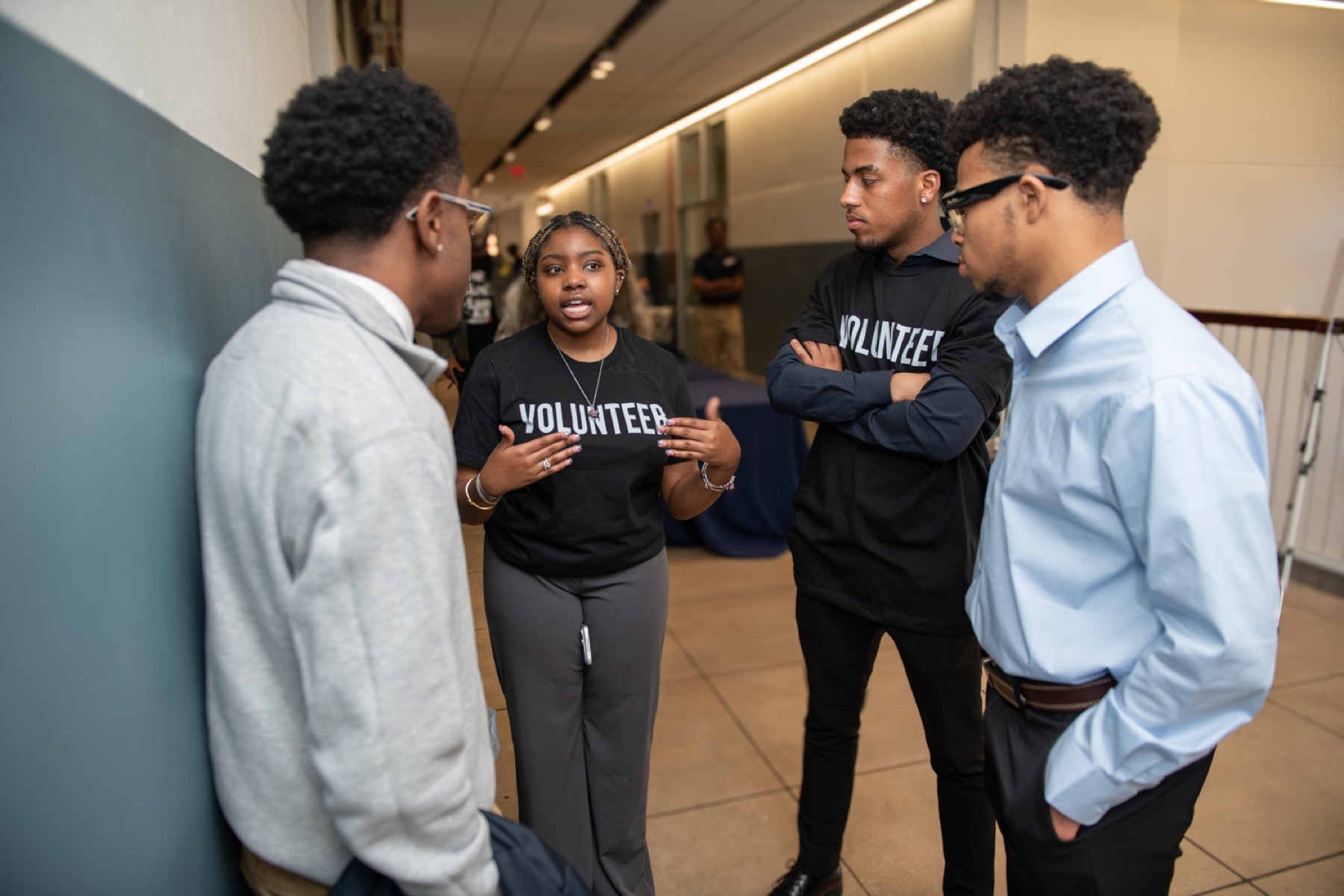 Student volunteers talking together at the 2026 Summit