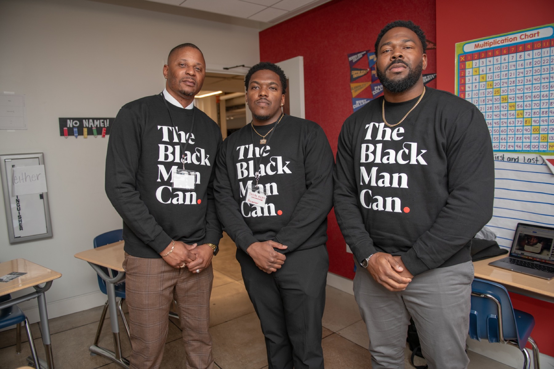 Three Black male educators in a classroom