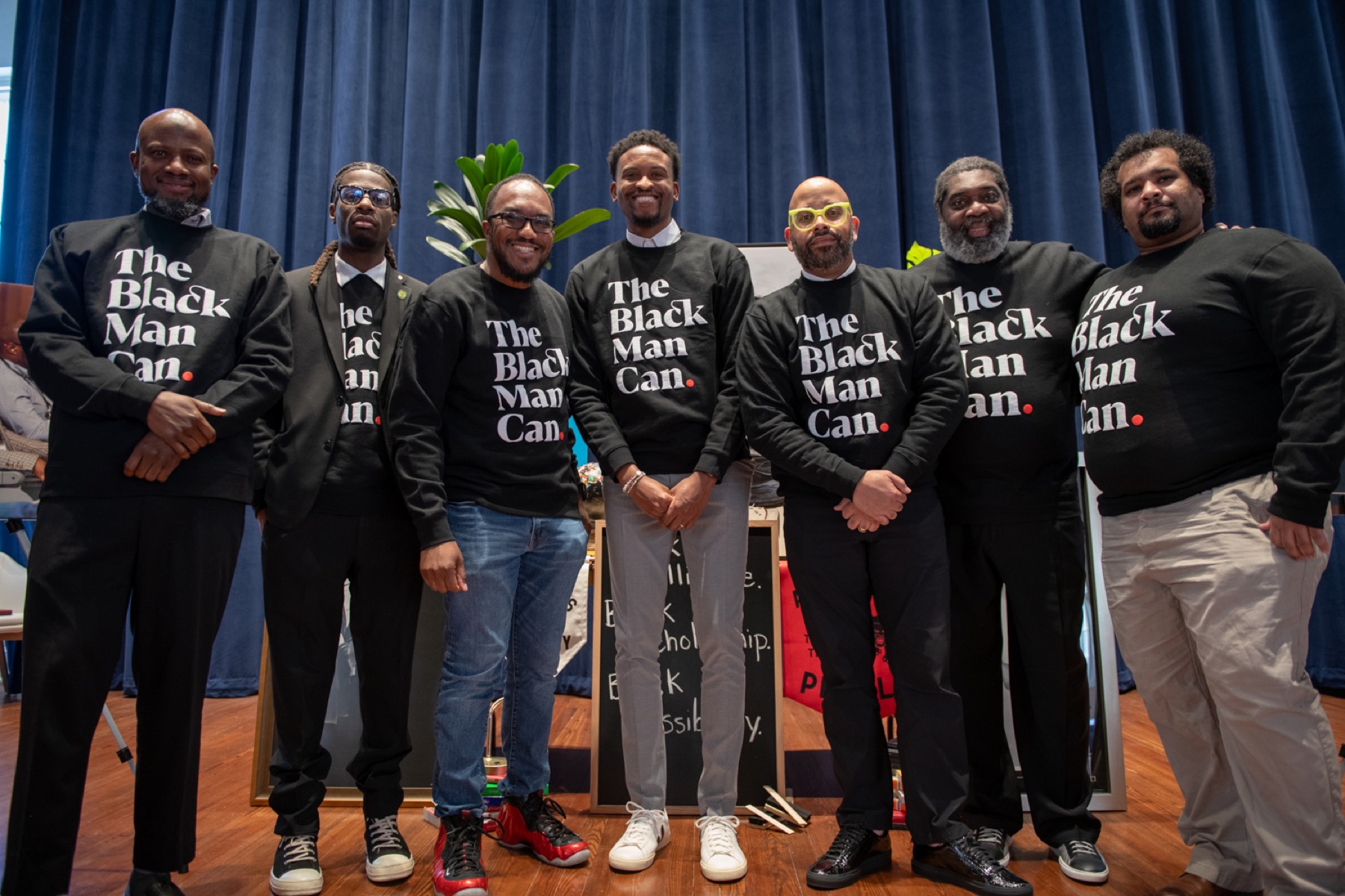 Black male educators standing together on the Summit stage
