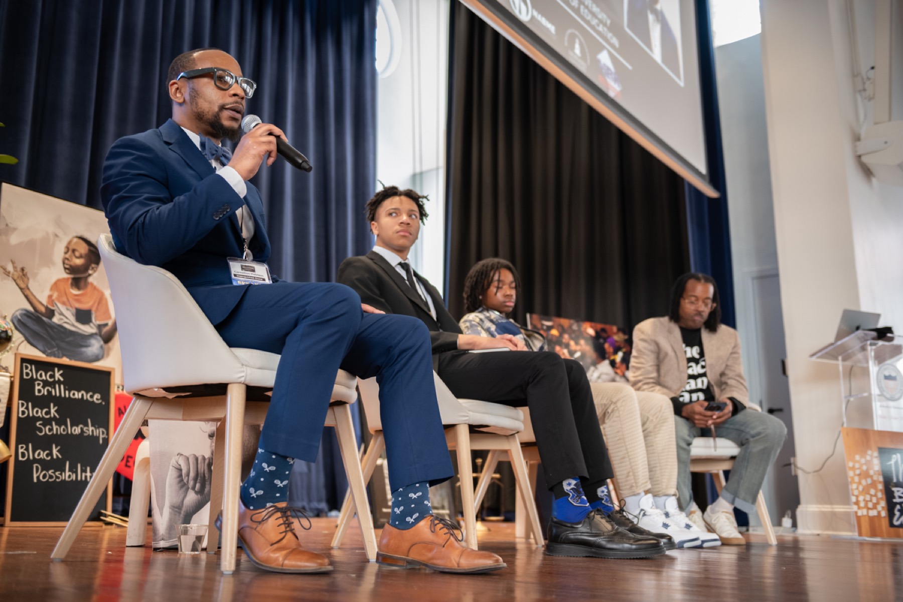 A speaker and students on a panel at the 2026 Summit